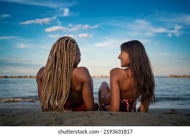 Young Friends Portrait Having Fun Laying On The Beach. View From Behind. Lifestyle Concept. 