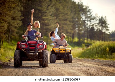 Young friends ride quads on a road in the nature. Extreme  sport