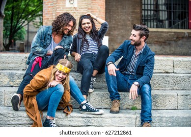 Young friends sitting on staircase having fun - Powered by Shutterstock