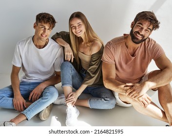 Young Friends Sitting And Smiling To The Camera 