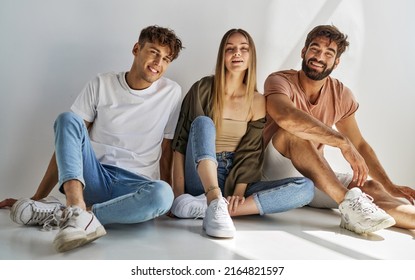 Young Friends Sitting And Smiling To The Camera 