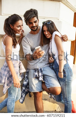 Similar – Young happy people looking tablet over table