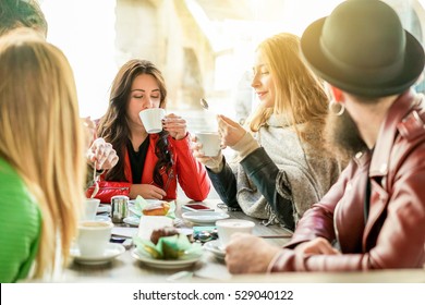 Young Friends Toasting Coffee And Doing Breakfast In Bar Bakery Shop - Happy Hipster People Drinking Cappuccino And Eating Muffins - Friendship Concept - Focus On Center Girl - Warm Filter