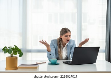 Young frustrated business woman office worker trying to concentrate for her work while she sitting in the company office with old laptop computer and slow internet connection.