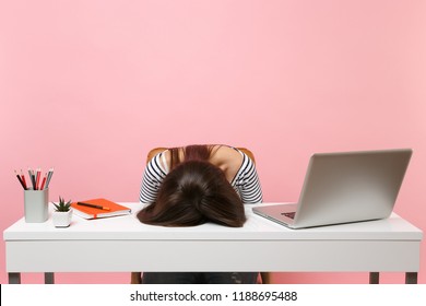 Young frustrated exhausted woman laid her head down on the table sit work at white desk with contemporary pc laptop isolated on pastel pink background. Achievement business career concept. Copy space - Shutterstock ID 1188695488