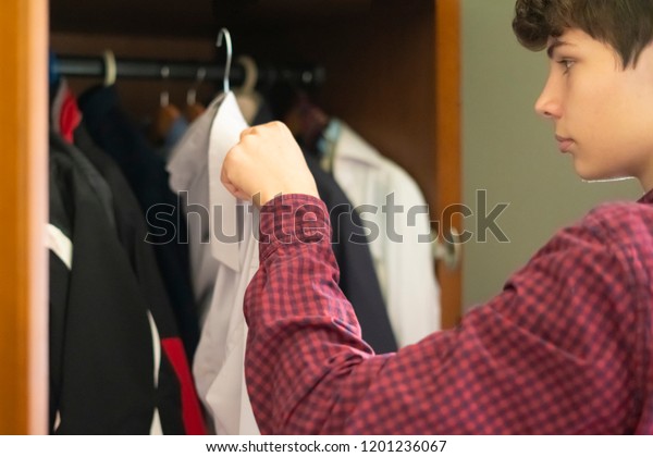 Young Frustrated Teenager Searching Suitable Clothes