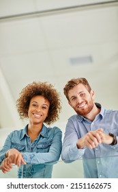 Young And Full Of Ambition. Portrait Of Two Colleagues Standing Together In An Office.