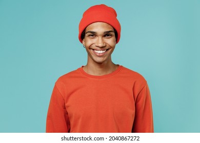 Young Fun Happy Smiling Satisfied Cheerful African American Man 20s Wearing Red Shirt Hat Looking Camera Isolated On Plain Pastel Light Blue Color Background Studio Portrait. People Lifestyle Concept.