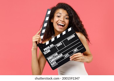 Young Fun Satisfied Excited Happy Cheerful African American Woman 20s Wearing Casual White Tank Shirt Holding Classic Black Film Making Clapperboard Isolated On Pink Color Background Studio Portrait