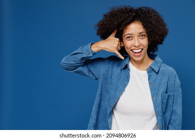 Young Fun Smiling Happy Black Woman In Casual Clothes Shirt White T-shirt Doing Phone Gesture Like Says Call Me Back Isolated On Plain Dark Blue Background Studio Portrait. People Lifestyle Concept