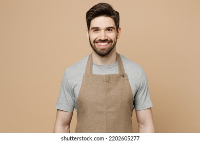 Young fun smiling happy caucasian man barista barman employee wear brown apron work in coffee shop looking camera isolated on plain pastel light beige background studio. Small business startup concept - Powered by Shutterstock