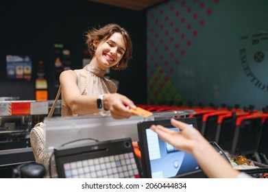 Young Fun Woman 20s In Casual Clothes Shopping At Supermaket With Grocery Cart Put Credit Card To Modern Bank Payment Terminal To Process Acquire Payments At Checkout Near Cashier Inside Store Cafe