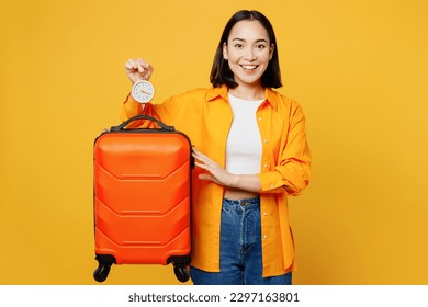 Young fun woman wear summer casual clothes use luggage scales check weight isolated on plain yellow background. Tourist travel abroad in free spare time rest getaway. Air flight trip journey concept - Shutterstock ID 2297163801