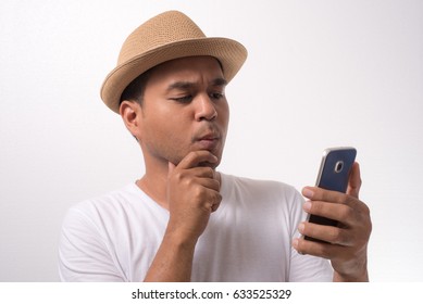 Young Funny Asian Man Using Smartphone And Confused
