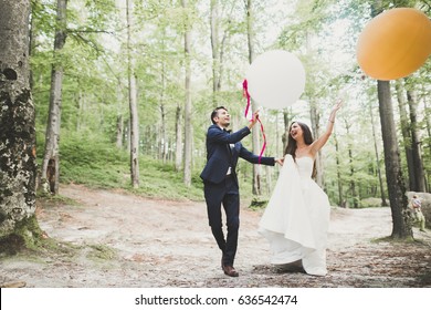 Young Funny Happy Wedding Couple Outdoors With Ballons