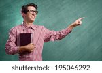 Young funny man in glasses against chalk blackboard
