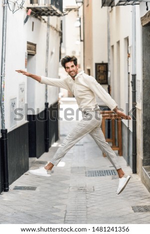 Similar – Young bearded man jumping in urban street