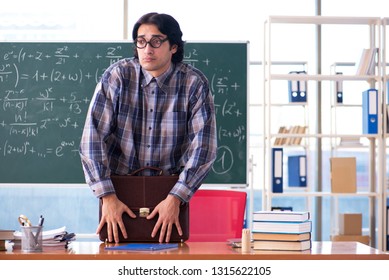 Young funny math teacher in front of chalkboard 