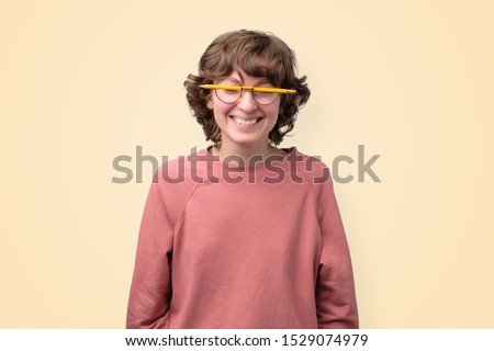 Young funny woman in glasses without lenses is tired to study.  
