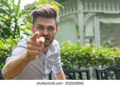 Young furious caucasian businessman shouting and pointing camera . Angry man and cursing .Anger, emotions, aggression,  Negative human emotions concept - Shutterstock ID 1010230042