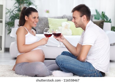 young future parents toasting with wine
