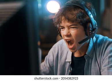 Young gamer connecting online and playing online video games, he is excited and shouting