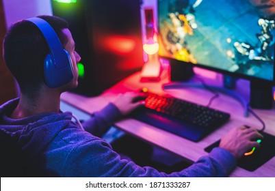 Young gamer playing online video games while streaming on social media - Youth people addicted to new technology game