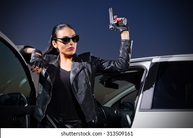 Young Gangster Woman With Gun Near The Car