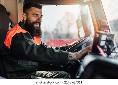 Young garbage removal worker driving a waste truck - Shutterstock ID 2148767311