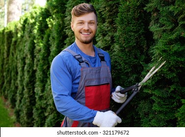 Young Gardener Cutting Trees With Clippers 