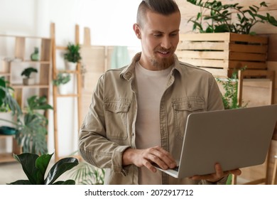 Young Gardener With Laptop At Home