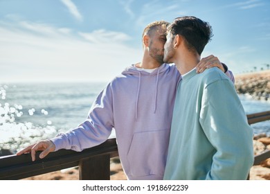 Young gay couple hugging and kissing at the beach. - Powered by Shutterstock