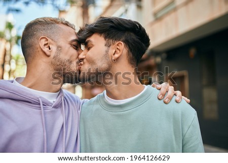 Young gay couple hugging and kissing at the city. Сток-фото © 