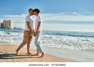 Young Gay Couple Kissing At The Beach.