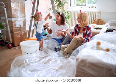 Young Gay Couple Moving In New House With A Toddler Girl
