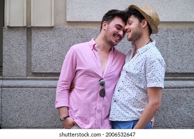 Young gay couple smiling and having an affection moment at street. - Powered by Shutterstock