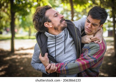 Young Gay Homosexual Couple, Men In Quarrel Conflict On The Verge Of A Physical Confrontation And A Fight. LGBT Relationship Disagree Concept. Partnership Disappointment