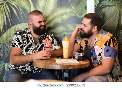 Young Gay Tourist Couple Having A Cocktail In A Tropical Beach Bar. Travel, Vacation And Summer Concept.