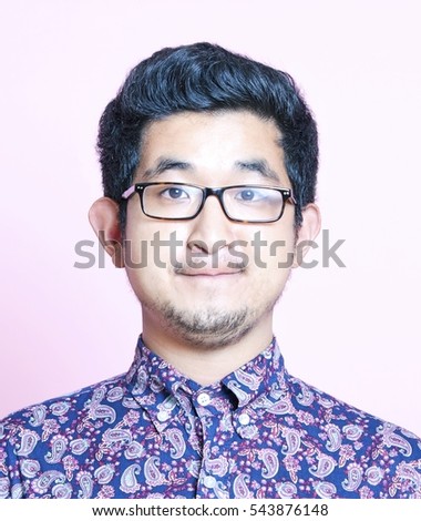 Young Geeky Asian Man in colorful shirt wearing glasses