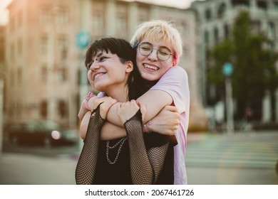 Young Gender Fluid Couple Hugging On City Street
