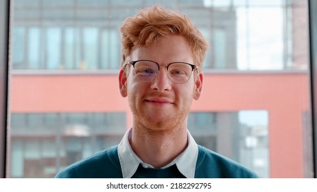 Young Ginger Irish Man In Glasses Smiling With Pleased Happy Expression And Looking At Camera Portrait. Millennial Male Freelancer Successful Entrepreneur,young Businessman Standing In Office. Slow Mo