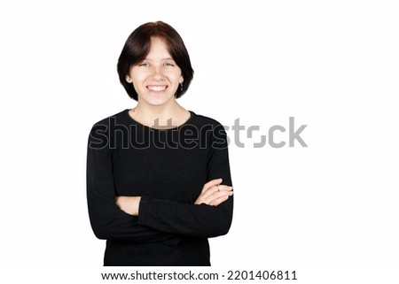 Young girl 14-16 years old teenager happy smiling in black sweater on white background, happy adolescence, girl successful at school. Isolated