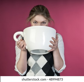 Young girl about to drink from extra large cup