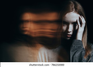 Young girl addicted to drugs with hallucinations against blurred background - Shutterstock ID 786232000