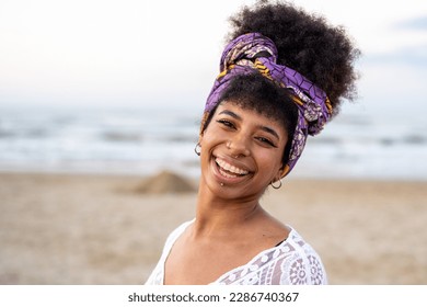 Young girl of African descent smiling at sea at sunset, smiling with brace for teeth - Powered by Shutterstock