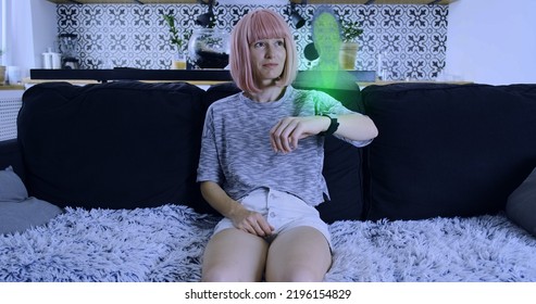 Young girl answers holographic video call of the future with man. Smart watch projecting semi-transparent screen into space. Living room, indoors, medium shot. - Powered by Shutterstock