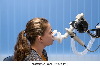 A Young Girl With Asthma In The Hospital Having A Lung Function Test.