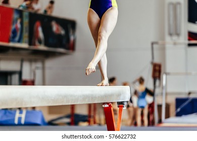 Young Girl Athlete Gymnast On Balance Beam Competition In Gymnastics