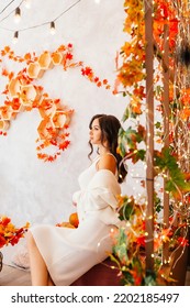 A Young Girl In Autumn, In A White Dress And Jacket In Autumn Scenery With Long Loose Hair Curls