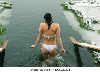 young girl bathing in an ice hole